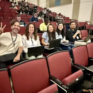 Attendees smiling together during a hands-on All Things AI program